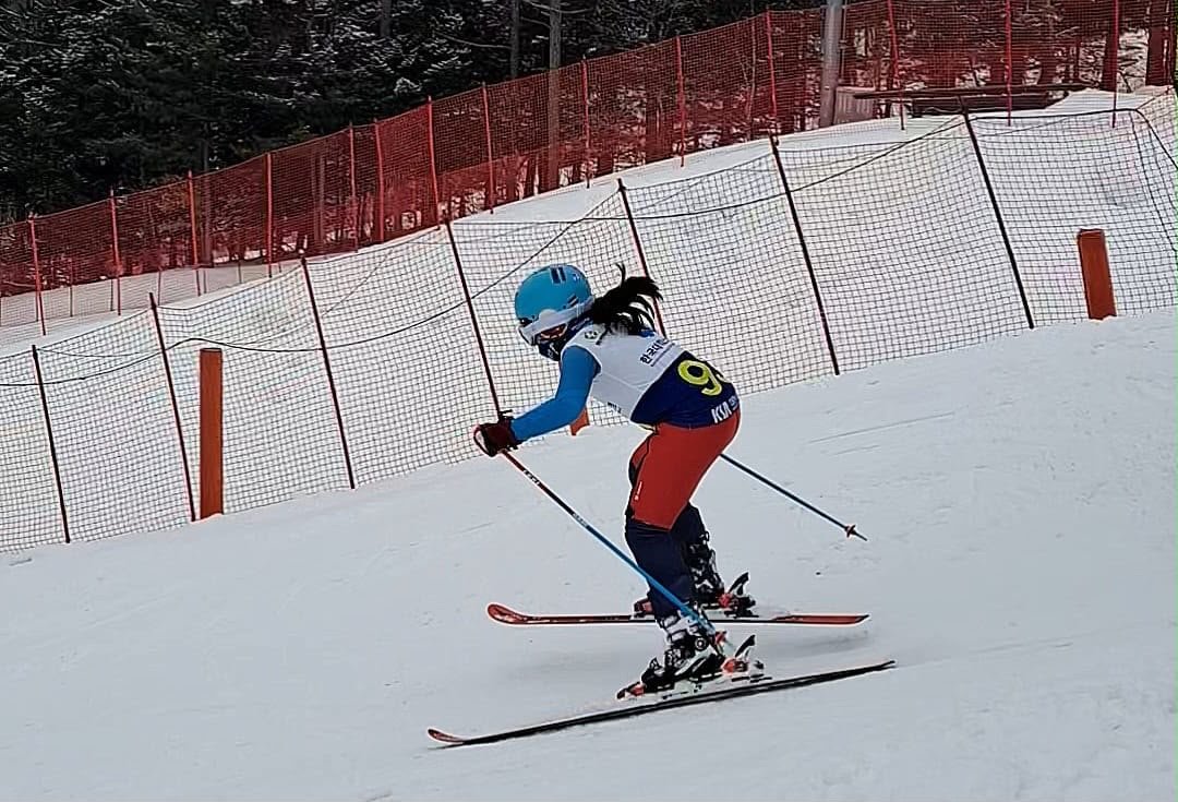 A young ski racer training on a slalom race course