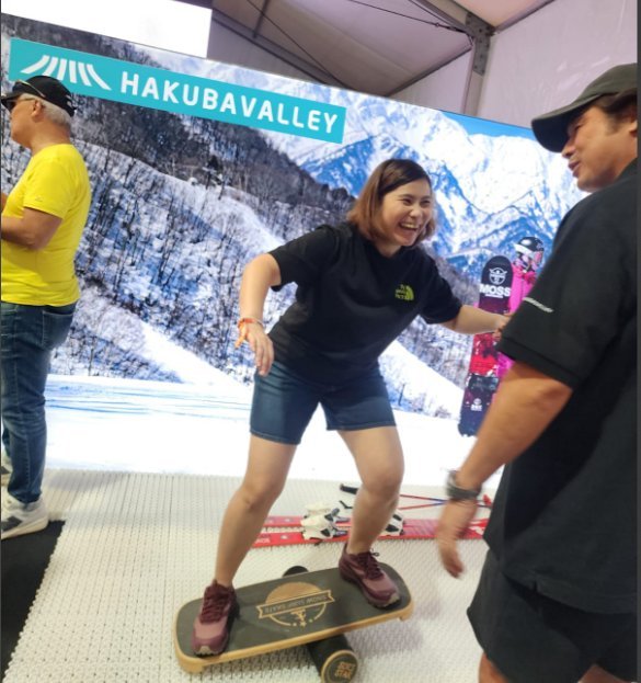 Visitor trying a balance-board simulator at the expo